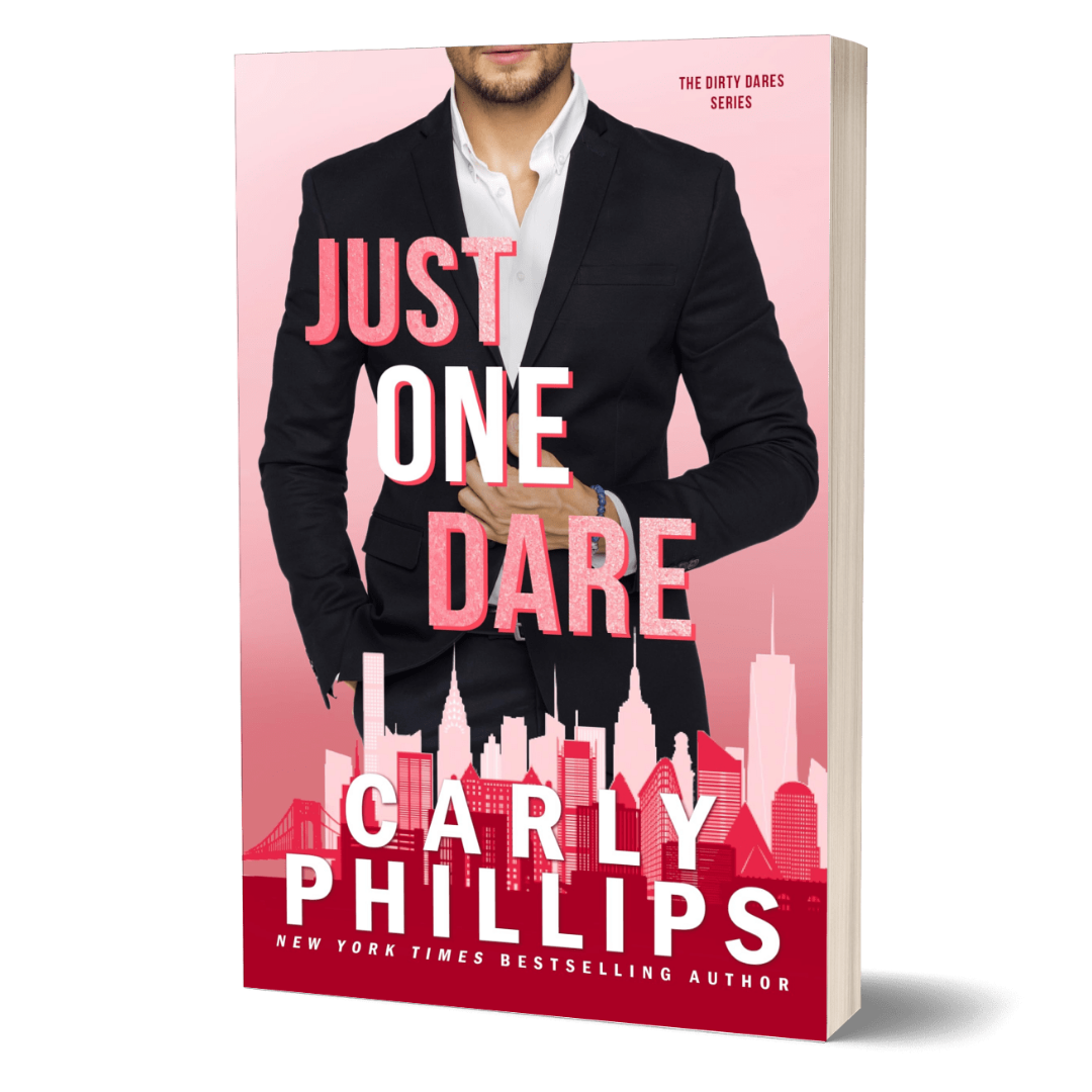 Book cover of 'Just One Dare' by Carly Phillips with a man in a suit on a pink background
