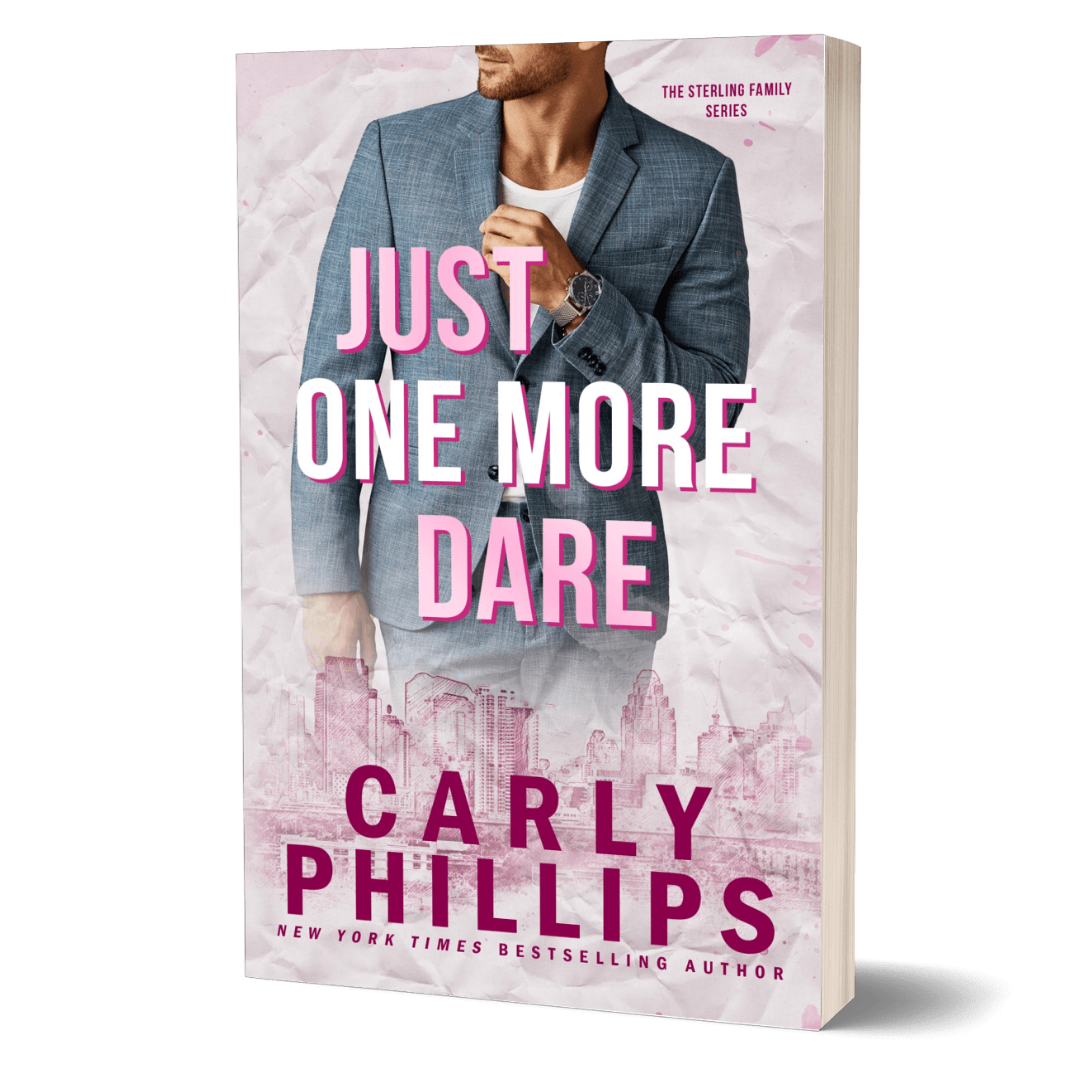 Book cover of 'Just One More Dare' by Carly Phillips with a sexy man in a suit on a pink background.